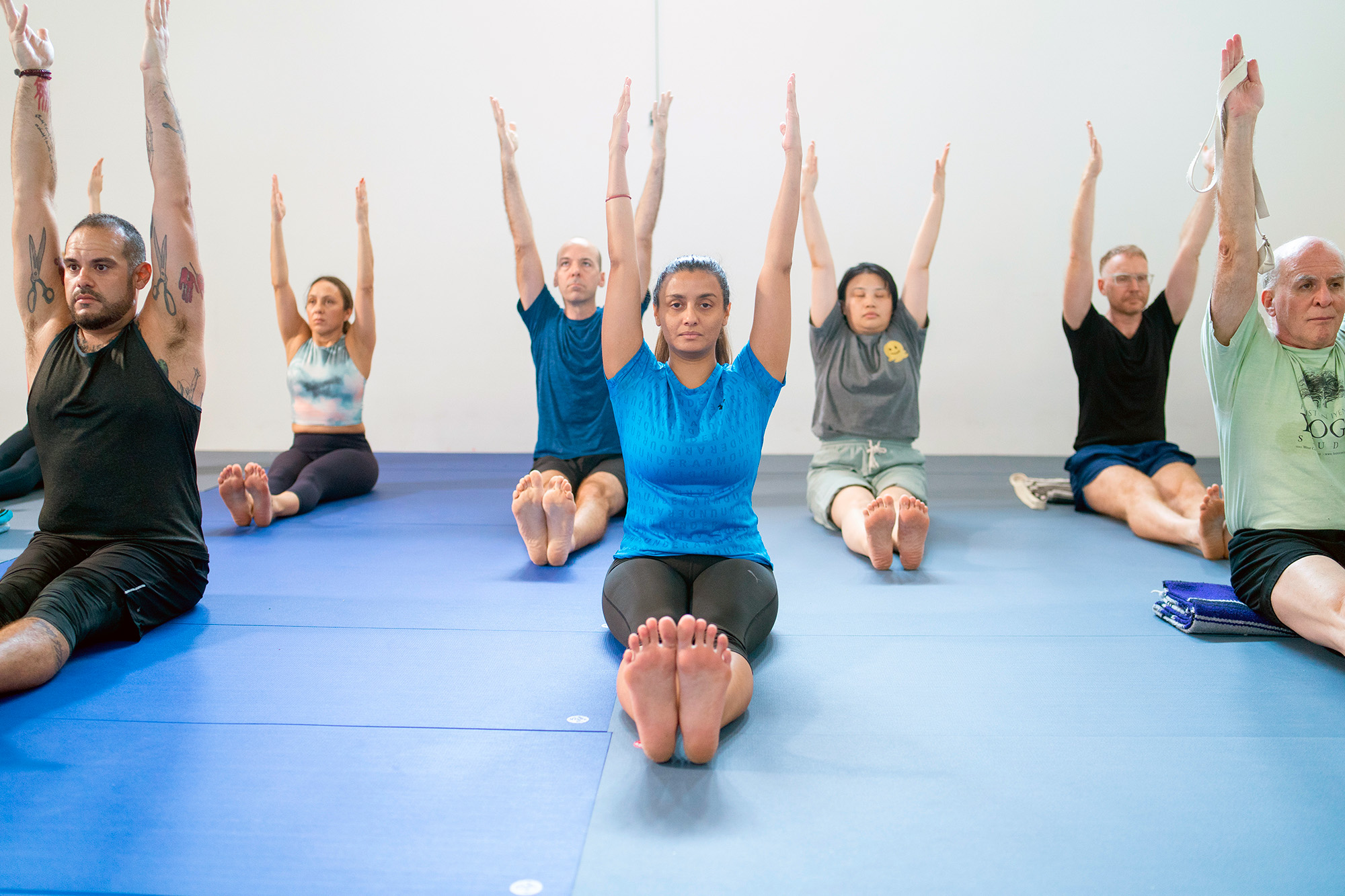 Photo of students in Dandasana (Staff Pose) at Houston Iyengar Yoga Studo class